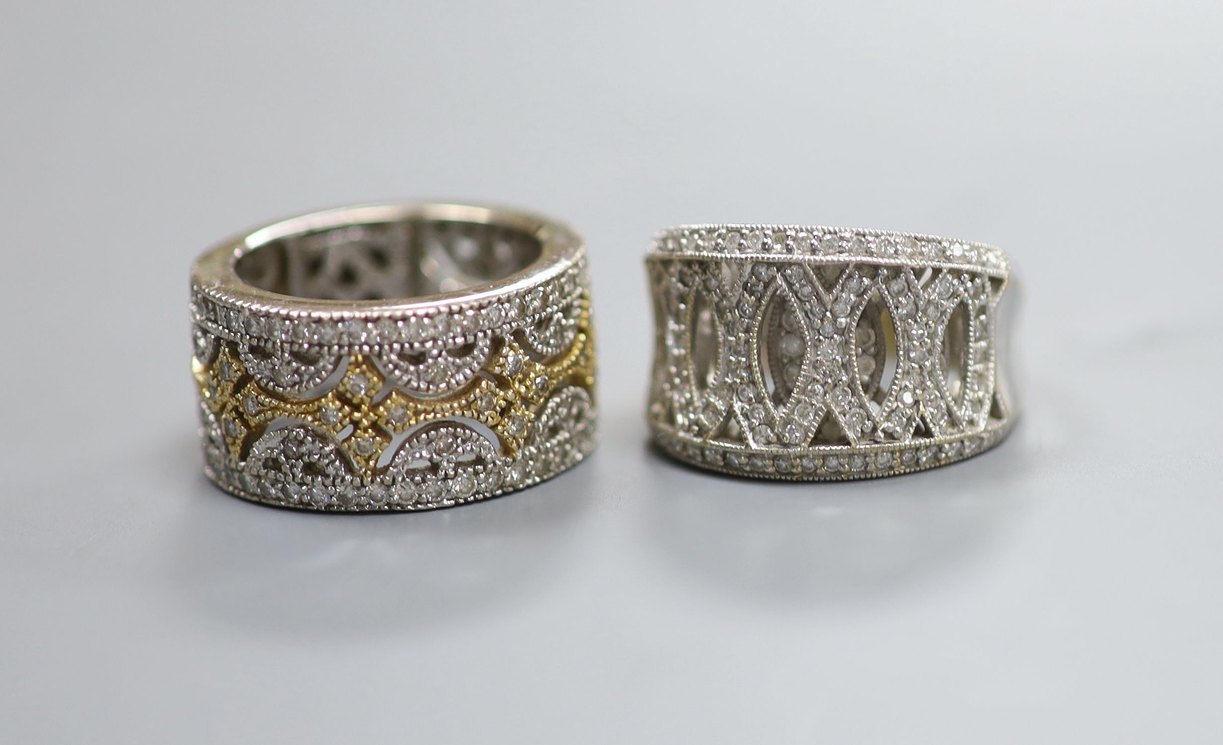 Two modern pierced yellow and white metal, diamond chip cluster rings, sizes K M, gross weight 18.9 grams.